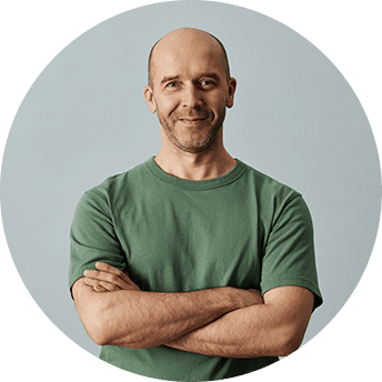 Man in green shirt with crossed arms.