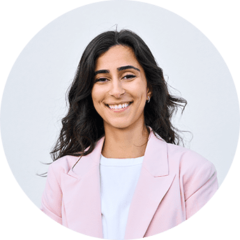 Smiling person in a pink blazer.