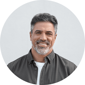 Smiling man with gray hair and beard.