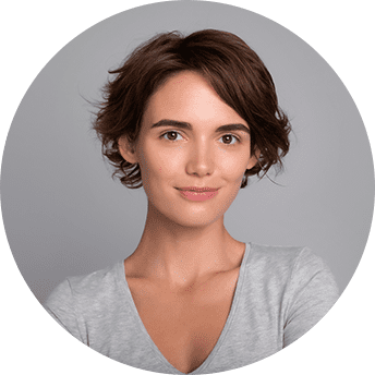 Woman with short brown hair smiling confidently.